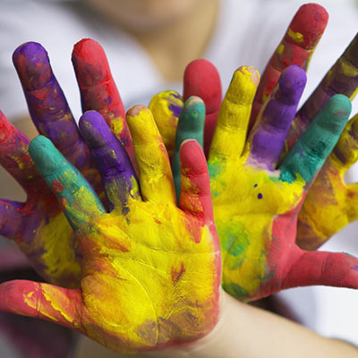 bunch of children's fingerpaint stained hands